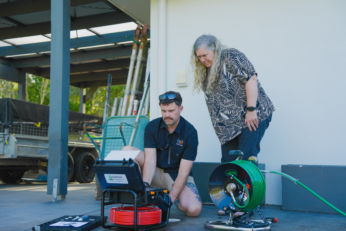 Joel showing a customer the drain camera footage