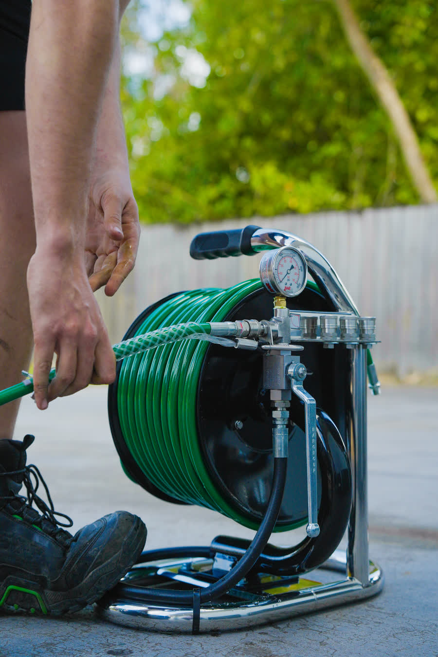 Hands on the high-pressure drain jetter reel