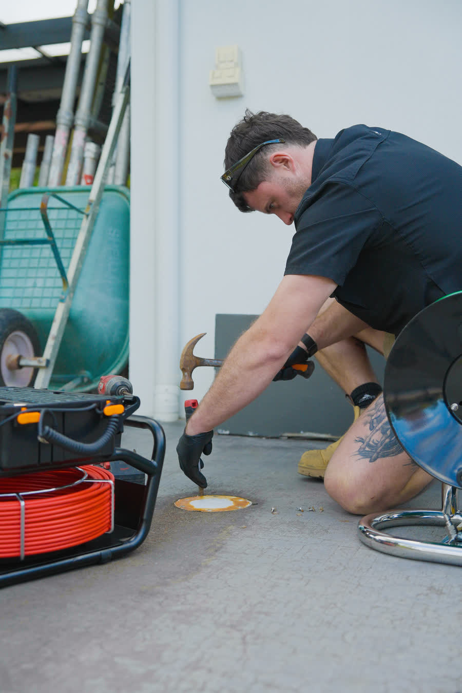 Joel opening a drain cap before a camera inspection