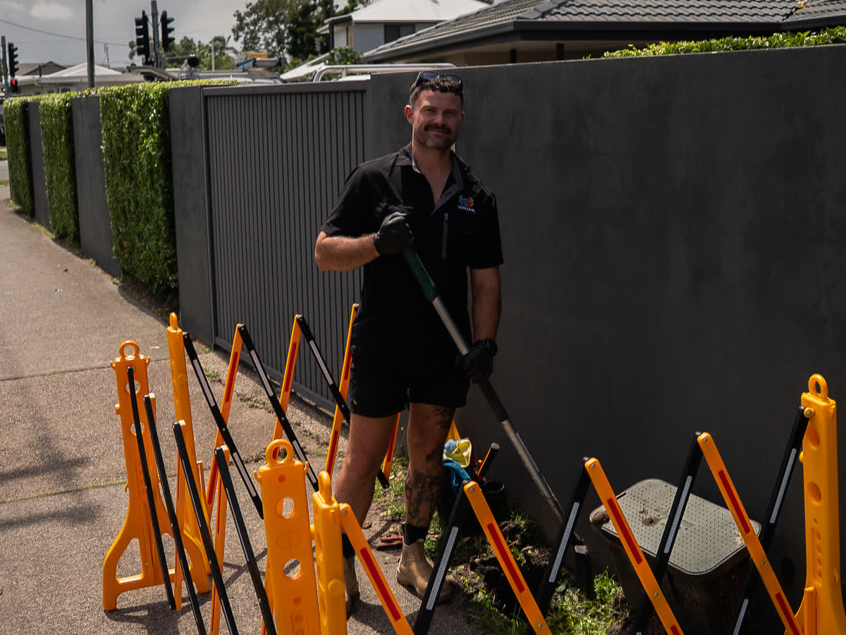 Joel on a street-front job behind safety barriers