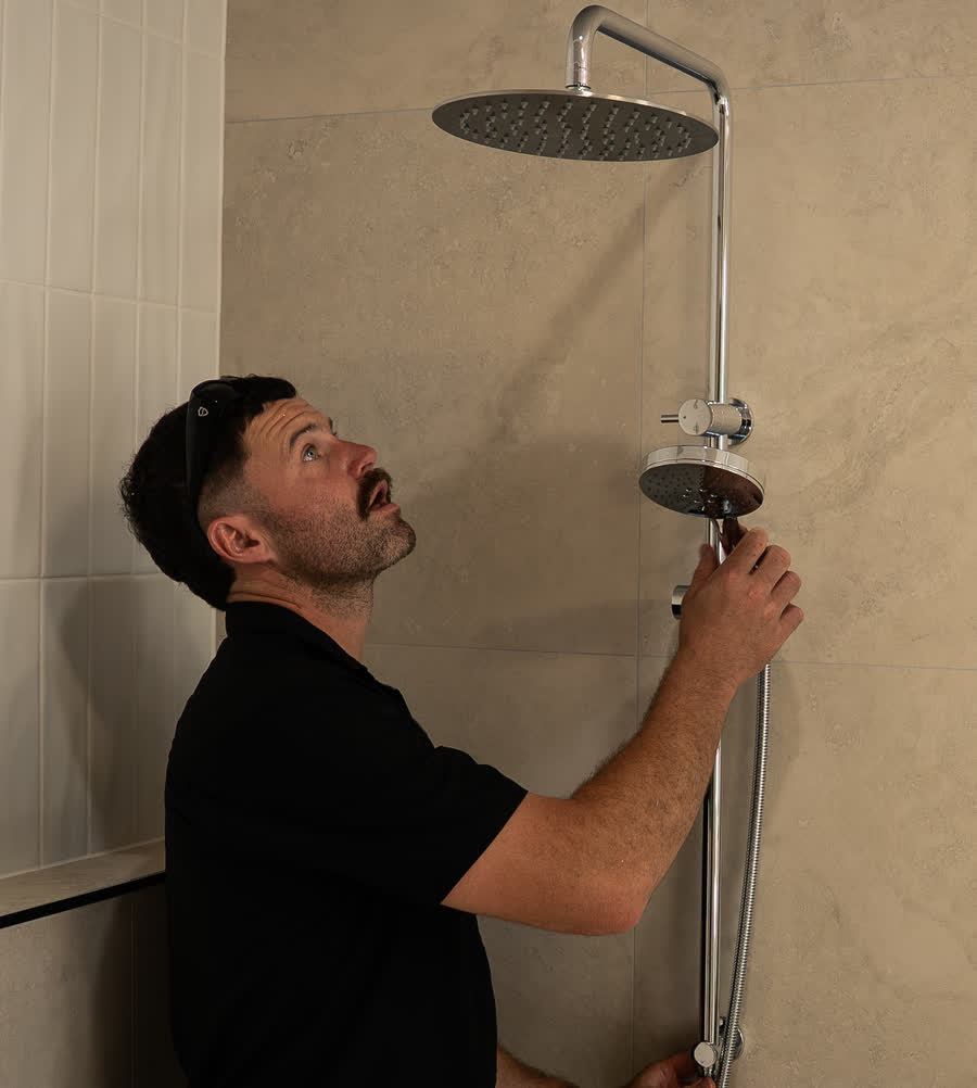 Joel checking a shower mixer for leaks